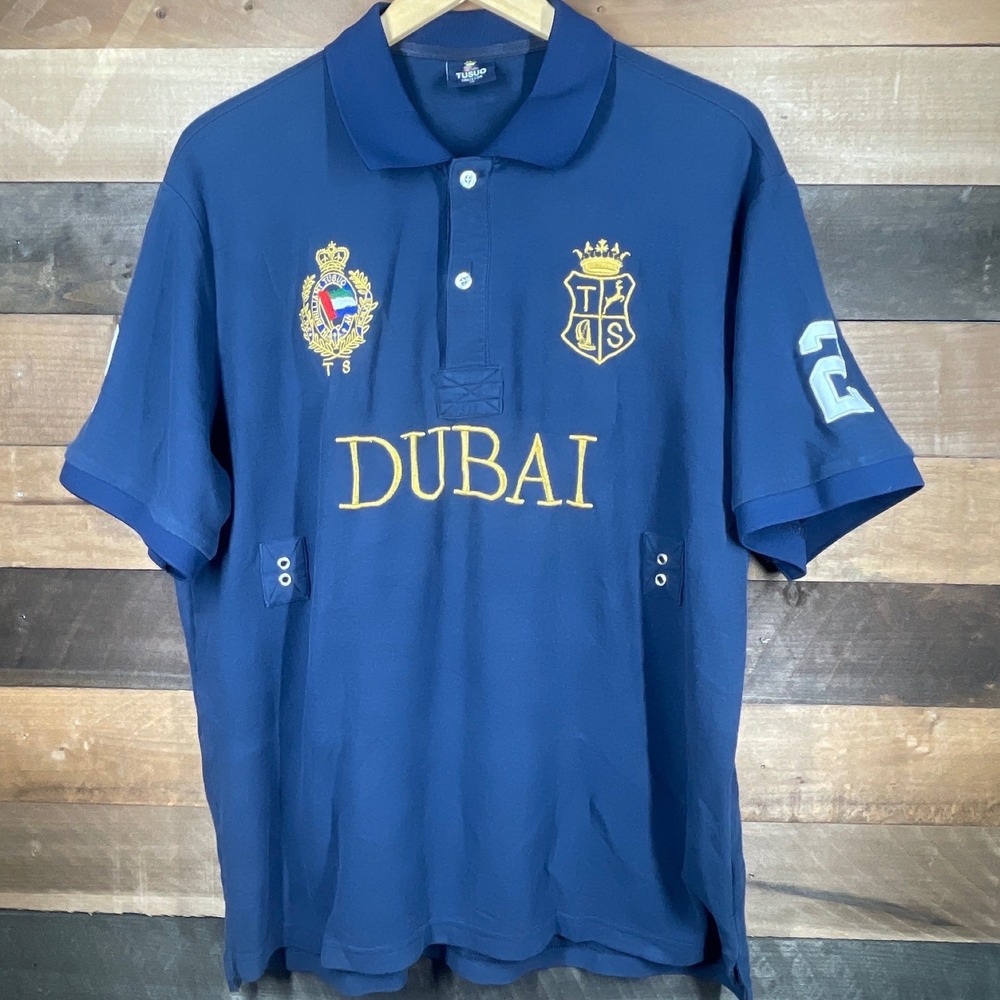 TUSUO Mens XL Blue Dubai Polo Shirt Gold Crests Spell Out Golf Casual